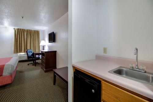 a hotel room with a sink and a bed at Motel 6-Marion, IL in Marion
