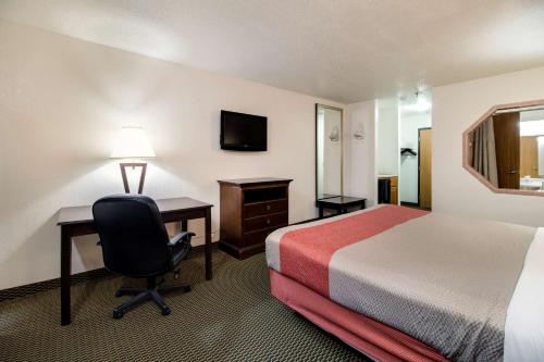 a hotel room with a bed and a desk and a chair at Motel 6-Marion, IL in Marion