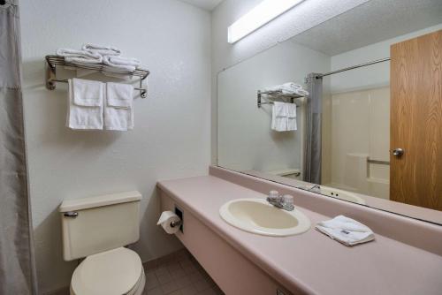 a bathroom with a sink and a toilet and a mirror at Motel 6-Marion, IL in Marion
