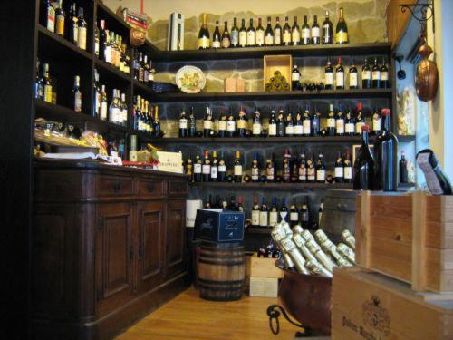 a bar filled with lots of bottles of alcohol at Hotel Da Cesare in Stresa
