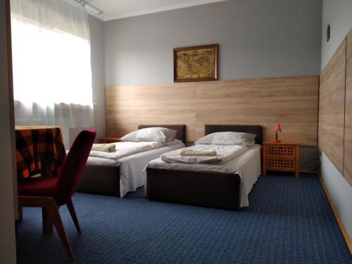 Ένα ή περισσότερα κρεβάτια σε δωμάτιο στο Hotelik Krakowiak