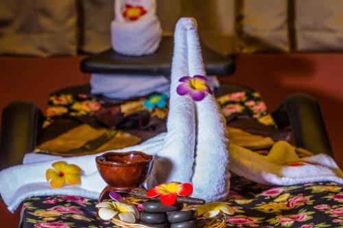 a table with towels and a plate of food on it at Arch Hotel in Manama