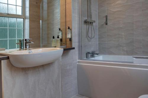 a white bathroom with a sink and a shower at Best Western New Kent Hotel in Newcastle upon Tyne