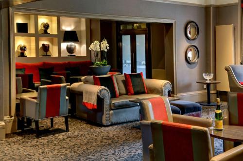 a living room with a couch and chairs and a table at Best Western Garfield House Hotel in Chryston