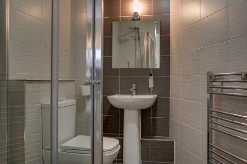 a bathroom with a sink and a toilet and a mirror at Best Western New Kent Hotel in Newcastle upon Tyne