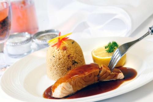 a plate of food with a fish and a fork at Best Western Balgeddie House Hotel in Glenrothes
