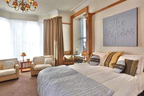 a bedroom with a large bed and a chandelier at Woodlands Hotel, BW Signature Collection in Dundee