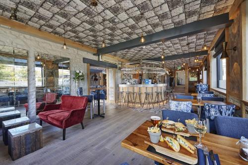 a restaurant with a table and chairs and a bar at Best Western Hotel de Havelet in St Peter Port