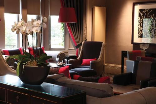 a waiting room with couches and chairs at Best Western Garfield House Hotel in Chryston
