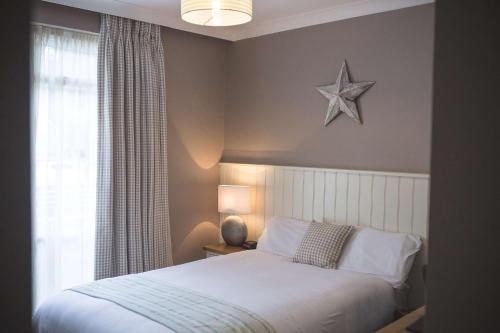 a bedroom with a bed and a star on the wall at George Hotel, BW Signature Collection in Norwich