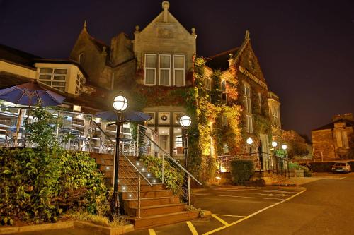 a building with a staircase leading up to it at night at Best Western Motherwell Centre Moorings Hotel in Motherwell