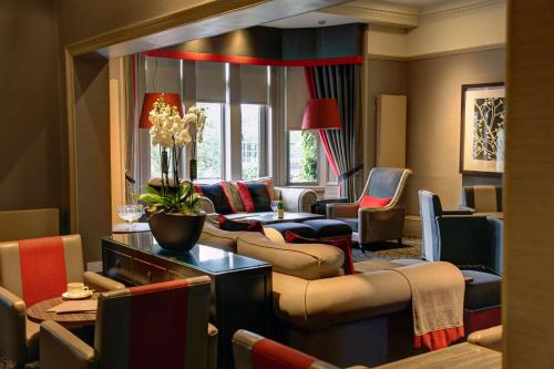 a living room with couches and chairs at Best Western Garfield House Hotel in Chryston