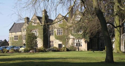 a large house with cars parked in front of it at Weston Hall Hotel Sure Hotel Collection by Best Western in Bulkington