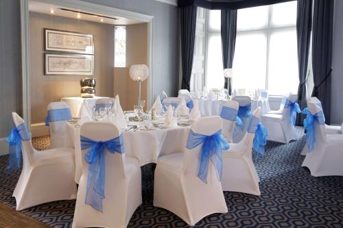 a room with white tables and chairs with blue bows at Best Western Motherwell Centre Moorings Hotel in Motherwell