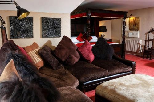 a living room with a couch and a bed at Best Western Premier Doncaster Mount Pleasant Hotel in Doncaster