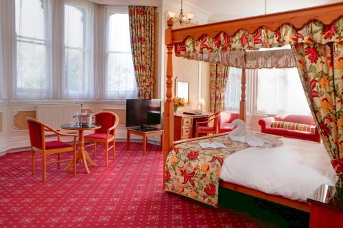 a hotel room with a bed and a table at Bestwood Lodge Hotel in Nottingham