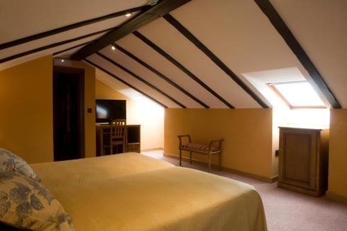 a bedroom with a large bed and a window at El Foyu in Colunga