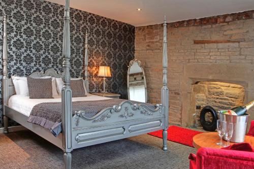 a bedroom with a bed and a brick wall at Best Western Plus Lancashire Manor Hotel in Skelmersdale