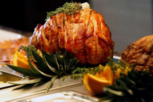 a turkey on a plate with oranges and other foods at Best Western Heath Court Hotel in Newmarket