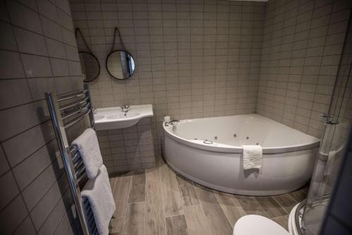 a bathroom with a tub and a sink at Roker Hotel BW Premier Collection in Sunderland