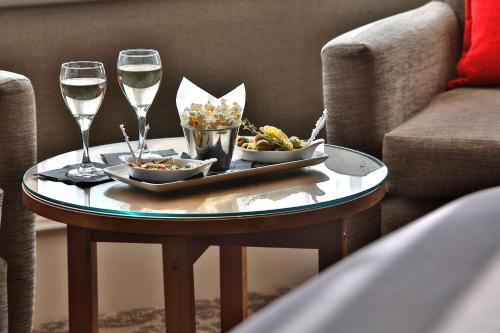 a table with two glasses of wine and a tray of food at Best Western Motherwell Centre Moorings Hotel in Motherwell