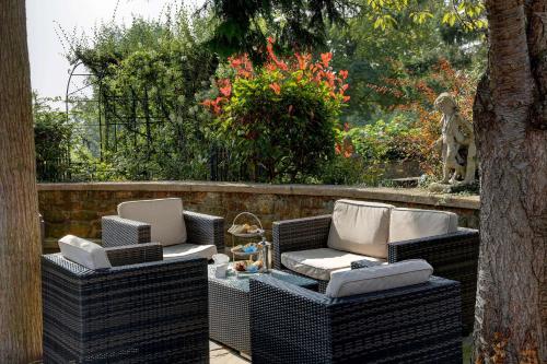 two wicker chairs and a table on a patio at Best Western Sysonby Knoll Hotel in Melton Mowbray