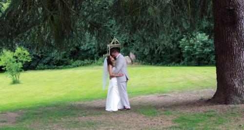 a bride and groom kissing under an umbrella at Weston Hall Hotel Sure Hotel Collection by Best Western in Bulkington
