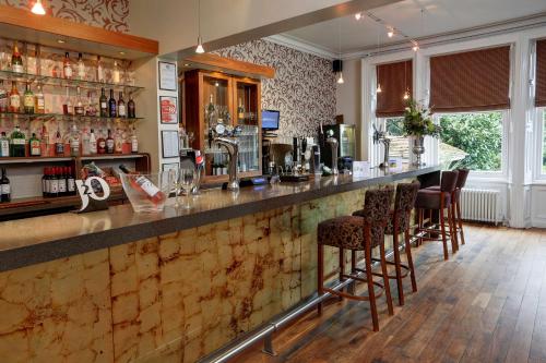 a bar in a pub with stools at Burn Hall Hotel in Huby