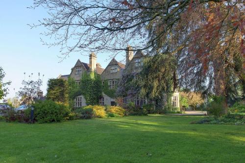 a large house with a green lawn in front of it at Weston Hall Hotel Sure Hotel Collection by Best Western in Bulkington