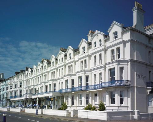 a large white building with a balcony on a street at Best Western York House Hotel in Eastbourne