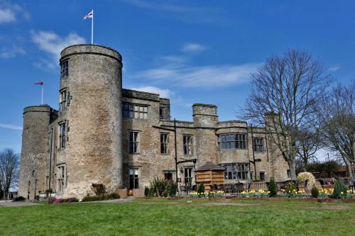 an old castle with a flag on top of it at Walworth Castle Hotel, BW Signature Collection in Darlington