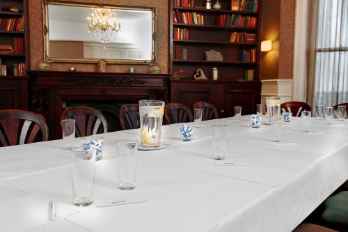 a long table with glasses on it in a library at Best Western Hotel Hatfield in Lowestoft