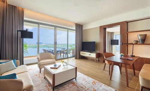 a living room with a couch and a table at Grand Hyatt Kochi Bolgatty in Cochin
