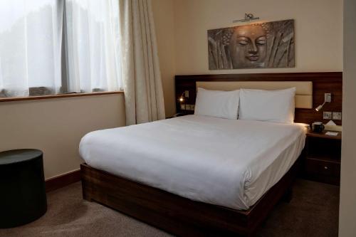 A bed or beds in a room at The Airlink Hotel London Heathrow 