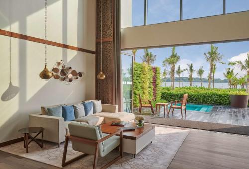 a living room with a couch and a table at Grand Hyatt Kochi Bolgatty in Cochin
