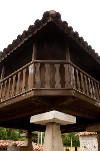 a wooden balcony on top of a building at El Foyu in Colunga