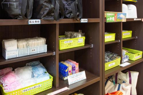 a store shelf filled with lots of different items at Kuretake Inn Gotemba Inter Gold Cabin in Gotemba
