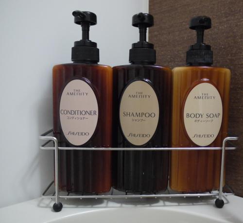 four bottles of wine sitting on a rack at Hotel Route-Inn Grand Muroran in Muroran