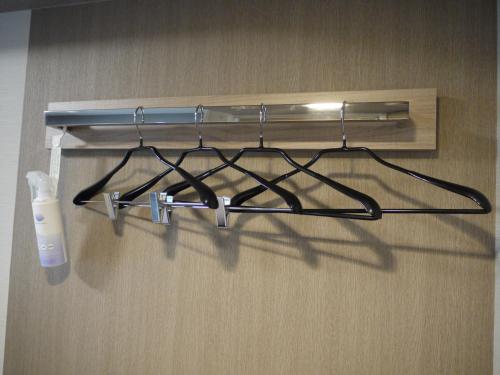 a group of glasses hanging on a wall at Hotel Route-Inn Grand Muroran in Muroran