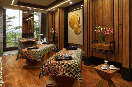 a hotel room with two beds and a mirror at Aston Sentul Lake Resort & Conference Center in Bogor