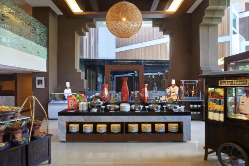 a buffet in a restaurant with food on display at Aston Sentul Lake Resort & Conference Center in Bogor