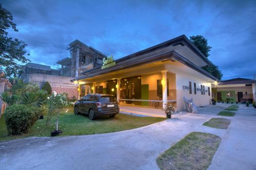 a truck parked in front of a house at Sulit Budget Hotel near Dgte Airport Citimall in Dumaguete