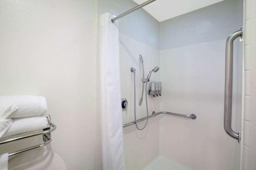 a bathroom with a shower with a shower curtain at Azure Hotel&Suites Ontario Trademark Collection by Wyndham in Ontario