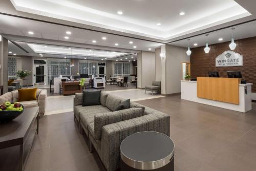 a lobby of a hotel with couches and a table at Wingate by Wyndham Page Lake Powell in Page