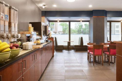 a kitchen with a counter with a bunch of fruits on it at Ramada Plaza by Wyndham Montreal in Montréal