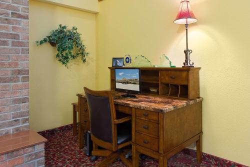 an office with a desk with a computer and a chair at AmericInn by Wyndham Republic in Republic