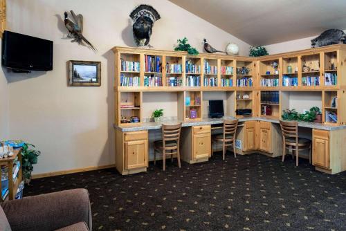 a room with a library with wooden book shelves at AmericInn by Wyndham Belle Fourche in Belle Fourche