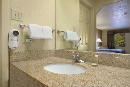 a bathroom with a sink in a hotel room at Super 8 by Wyndham Monroe in Monroe