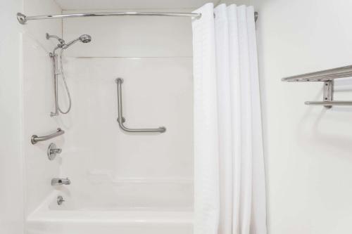 a shower with a white shower curtain in a bathroom at Super 8 by Wyndham Dixon in Dixon