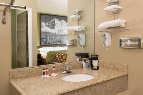 a bathroom with a sink in a hotel room at Super 8 by Wyndham Sterling CO in Sterling